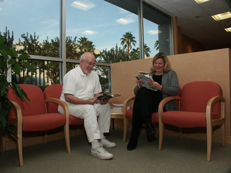 Smiling patients reading magazines in waiting room